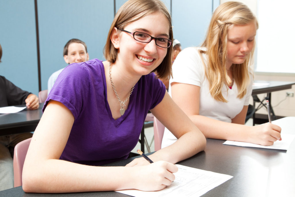 Teenage girls in high school class.  Real people.